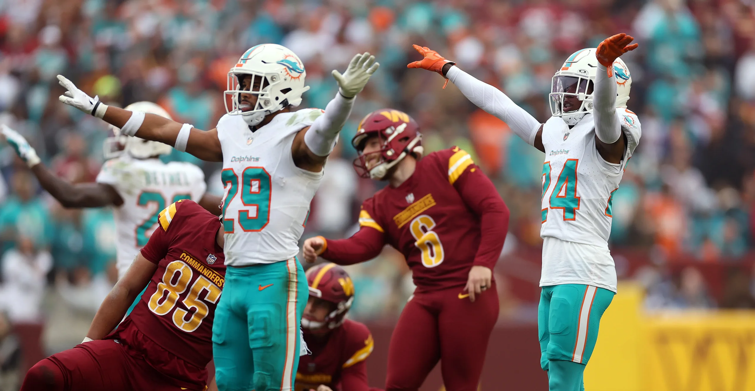 A pair of Miami Dolphins players celebrate the Washington Commanders missing a kick