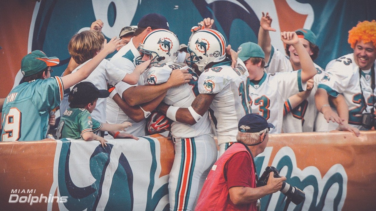 Miami Dolphins players celebrate in front of fans