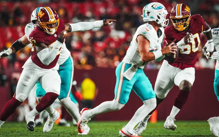 Miami Dolphins quarterback Quinn Ewers tries to evades the Commanders pass rush