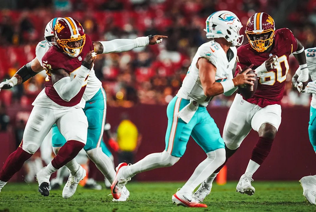 Miami Dolphins quarterback Quinn Ewers tries to evades the Commanders pass rush