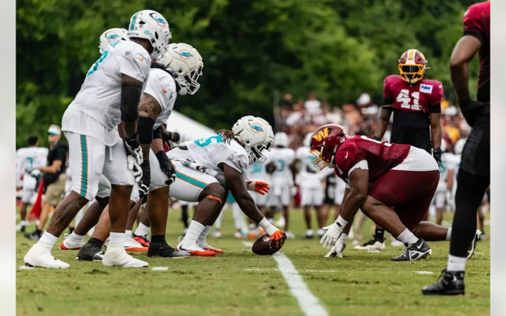 Miami Dolphins Center Aaron Brewer poised to snap the ball against the Washington Commanders