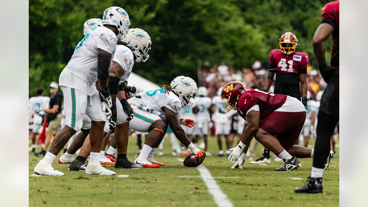 Miami Dolphins Center Aaron Brewer poised to snap the ball against the Washington Commanders