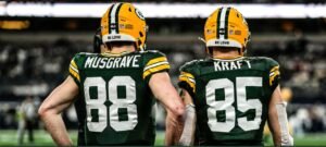 Green Bay tight end duo Luke Musgrave and Tucker Kraft stand on the sidelines